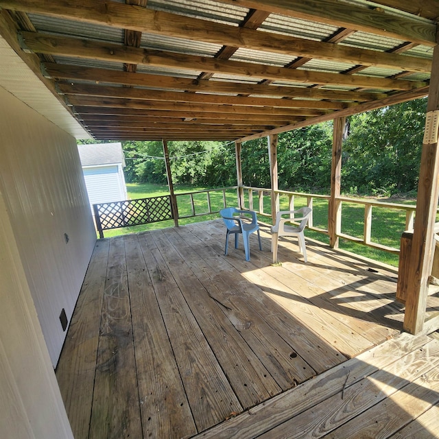 wooden terrace with a lawn