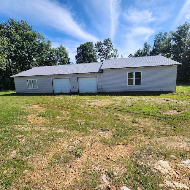 rear view of house featuring a lawn