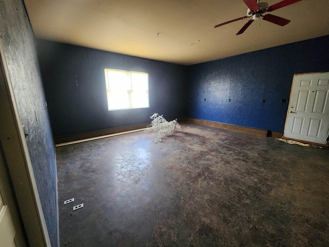 empty room with ceiling fan and concrete floors