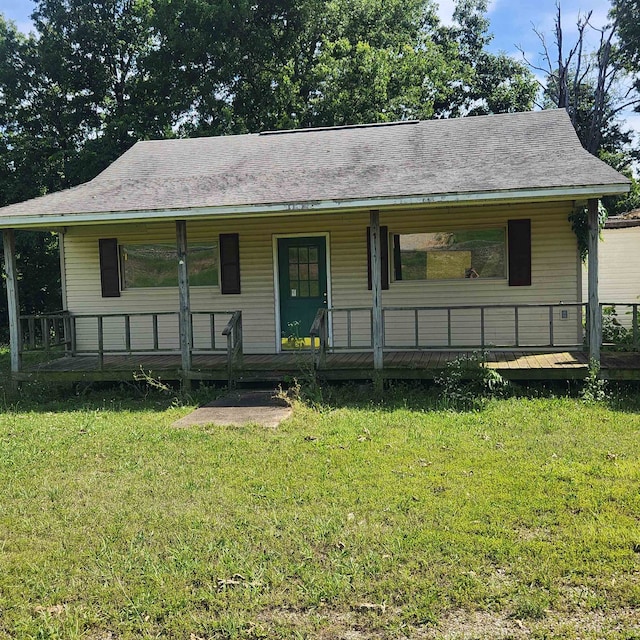 view of front facade with a front lawn and a wooden deck