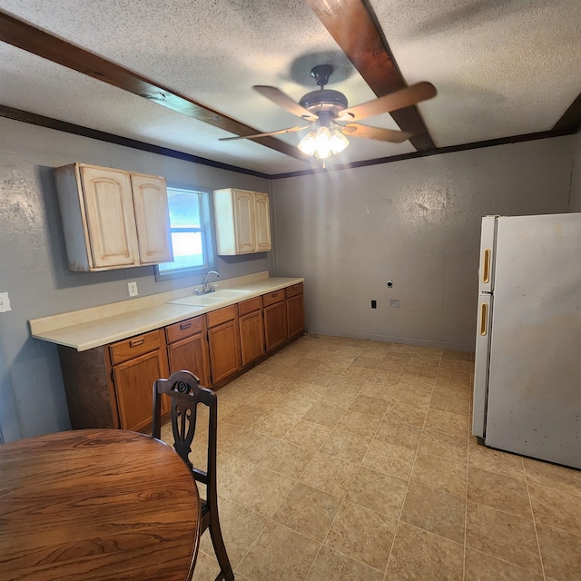 kitchen featuring ceiling fan, a textured ceiling, white fridge, and light tile floors