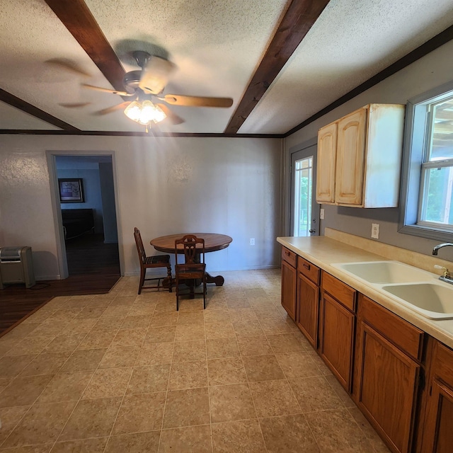 1947 63rd Hwy, Hardy, AR 72542 - kitchen featuring light countertops, a textured ceiling, a sink, beam ceiling, and a ceiling fan