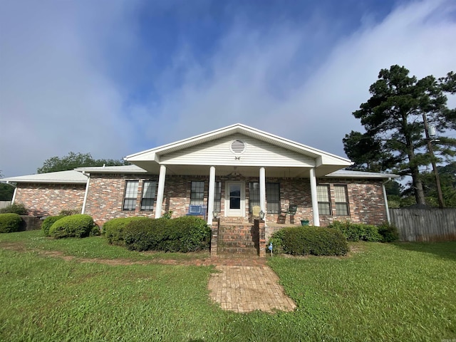 view of front of home with a front yard and a porch