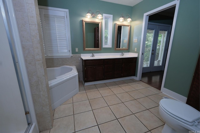 bathroom with vanity, a bath, french doors, tile patterned flooring, and toilet