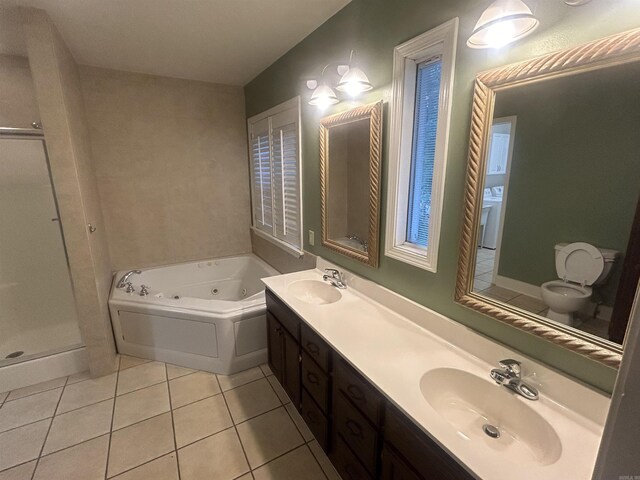 laundry area featuring washer and clothes dryer, light tile patterned flooring, and cabinets