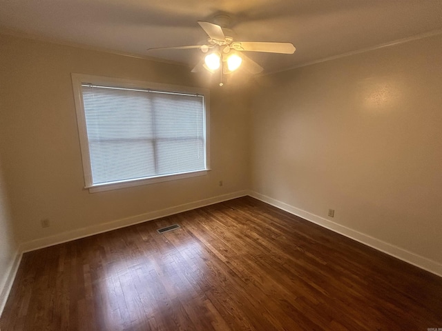 unfurnished room featuring dark wood finished floors, baseboards, visible vents, and ceiling fan