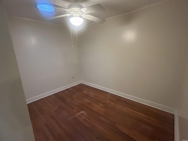 spare room with dark wood-type flooring, baseboards, and ceiling fan