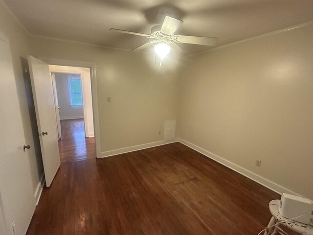 unfurnished room with ceiling fan, crown molding, and dark hardwood / wood-style floors