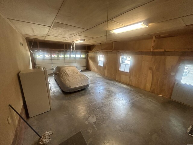 basement featuring wooden walls