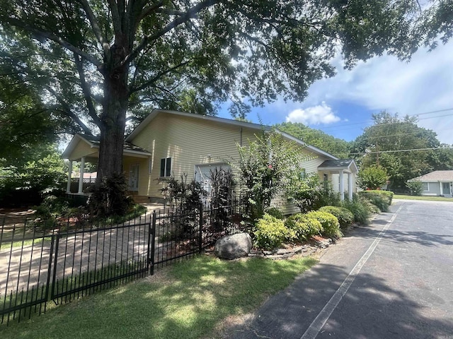 view of side of property featuring fence