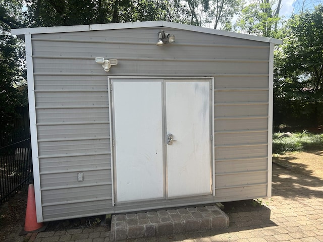 view of shed with fence