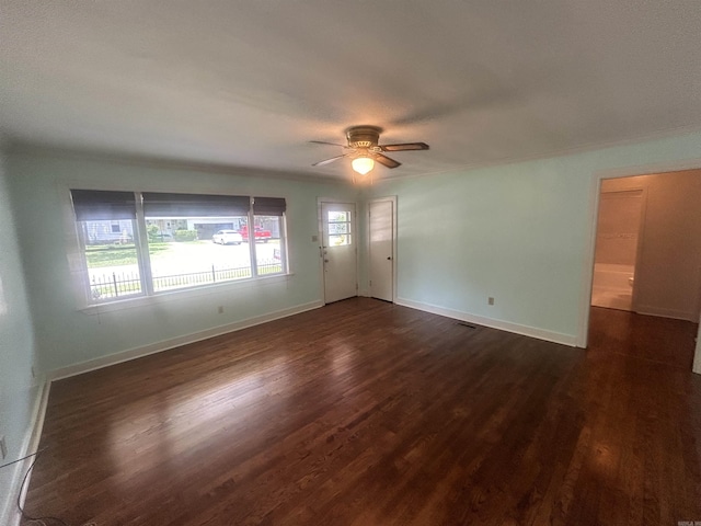 unfurnished room featuring baseboards, ceiling fan, and dark wood-style flooring