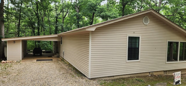 view of side of property with a carport