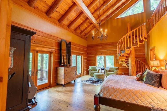 bedroom with wood-type flooring, high vaulted ceiling, and multiple windows