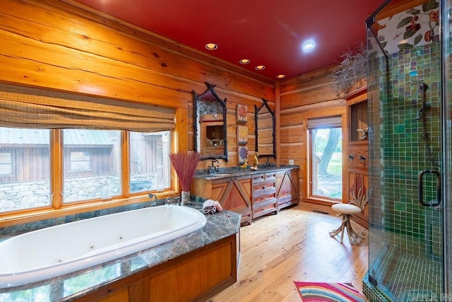 bathroom with vanity, wood-type flooring, shower with separate bathtub, and wooden walls