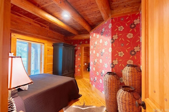 bedroom featuring light hardwood / wood-style flooring, beamed ceiling, and wooden ceiling