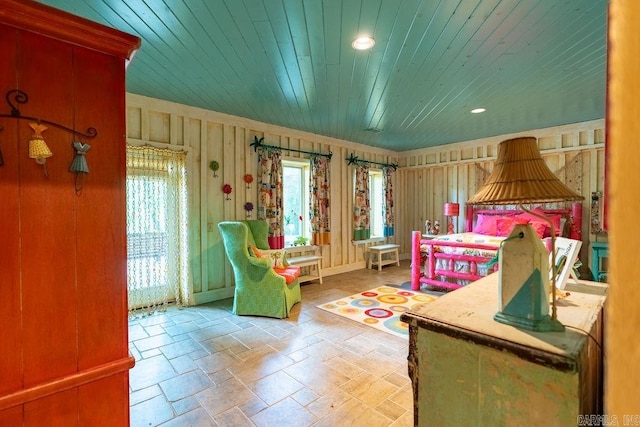 bedroom with wooden walls and wood ceiling