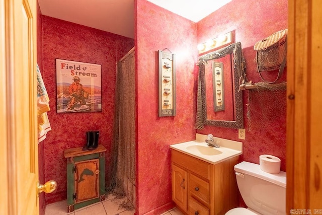 bathroom featuring tile patterned floors, vanity, and toilet