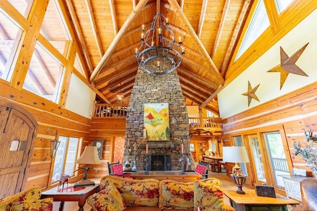 living room featuring wood ceiling, a fireplace, and high vaulted ceiling