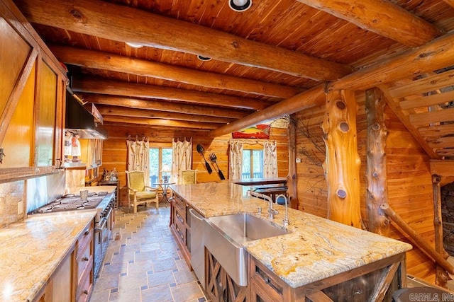 kitchen featuring beam ceiling, sink, and wooden ceiling