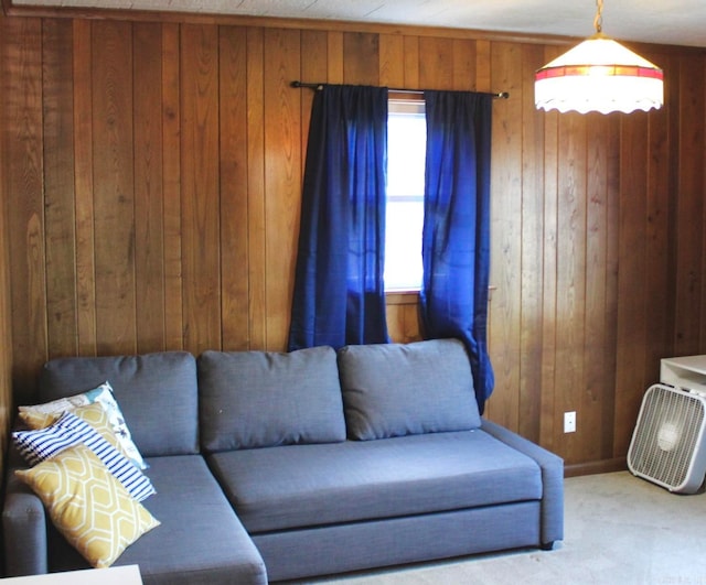 carpeted living room with wooden walls