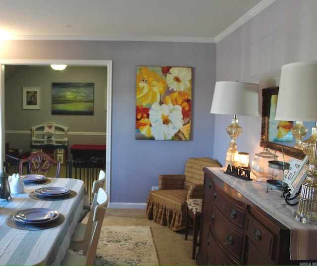 dining room featuring light colored carpet and crown molding