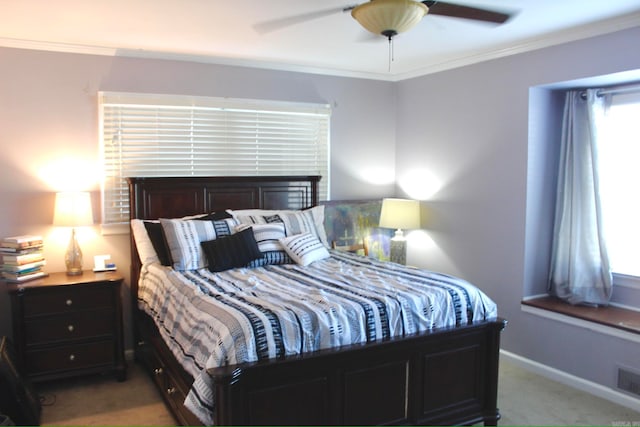 carpeted bedroom with ceiling fan and ornamental molding