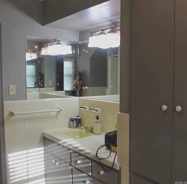 bathroom featuring backsplash and large vanity