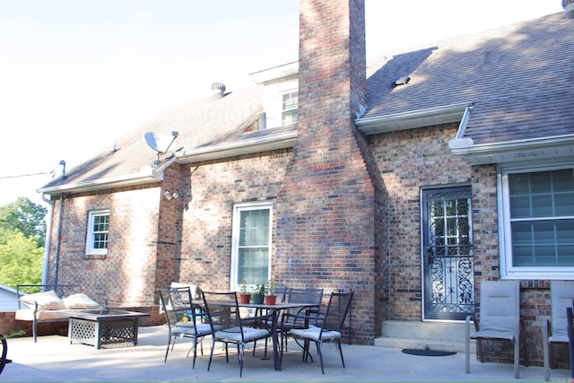 view of patio featuring an outdoor living space with a fire pit