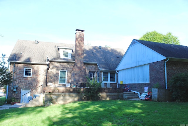 rear view of house featuring a yard