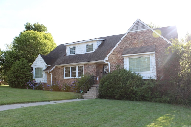 cape cod-style house with a front yard