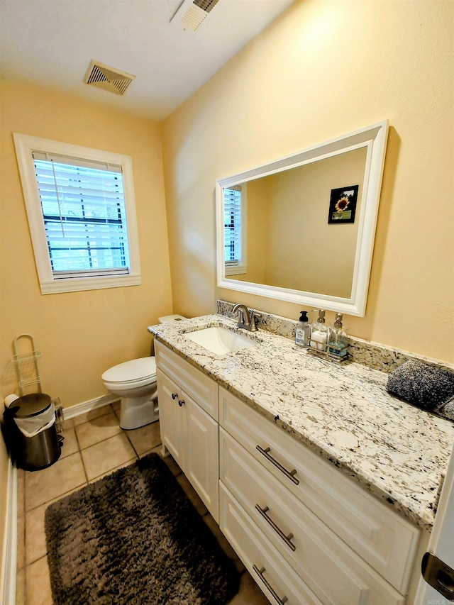 half bathroom with visible vents, toilet, tile patterned flooring, and vanity