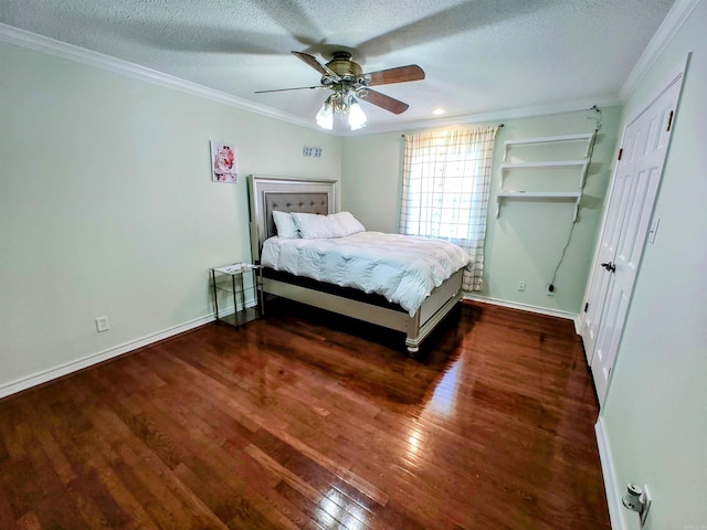 bedroom with baseboards, a textured ceiling, crown molding, and hardwood / wood-style flooring