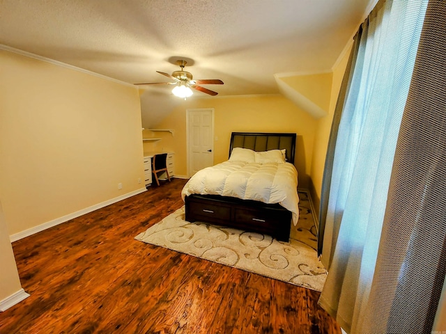 bedroom featuring crown molding, a ceiling fan, wood finished floors, a textured ceiling, and baseboards