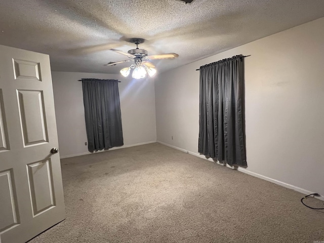 carpeted empty room featuring a textured ceiling and ceiling fan