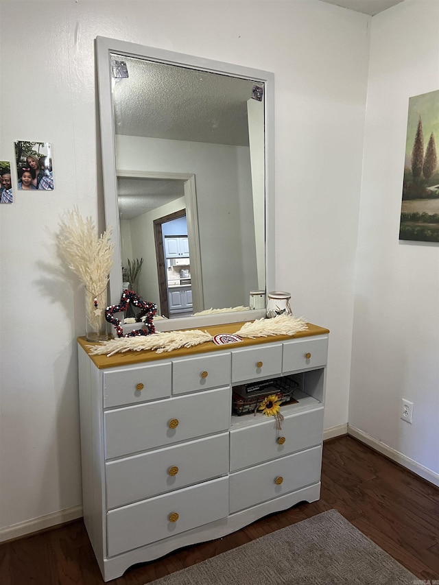 bathroom featuring hardwood / wood-style flooring, vanity, and a textured ceiling