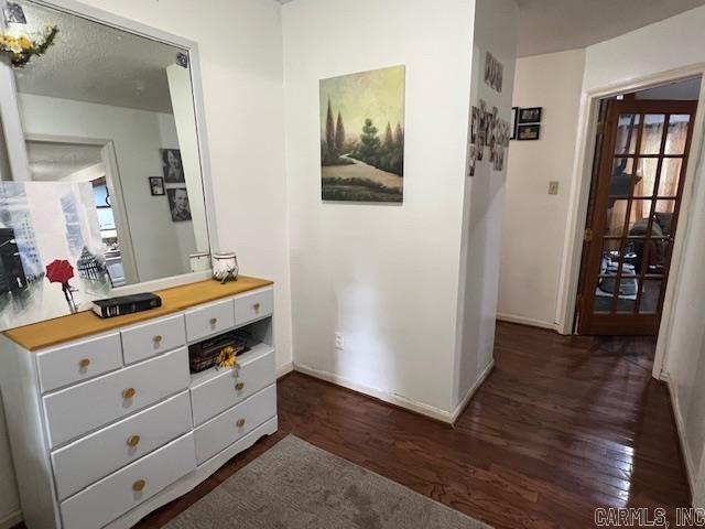 hall with dark hardwood / wood-style flooring