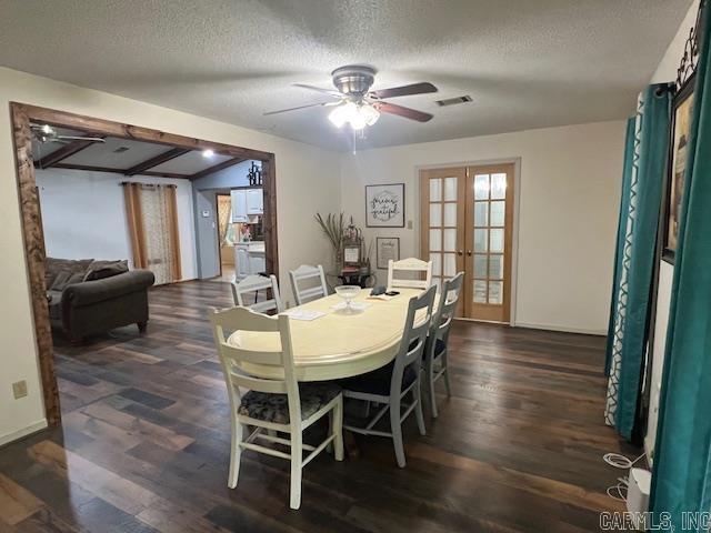 dining area with ceiling fan, french doors, dark hardwood / wood-style floors, and a textured ceiling