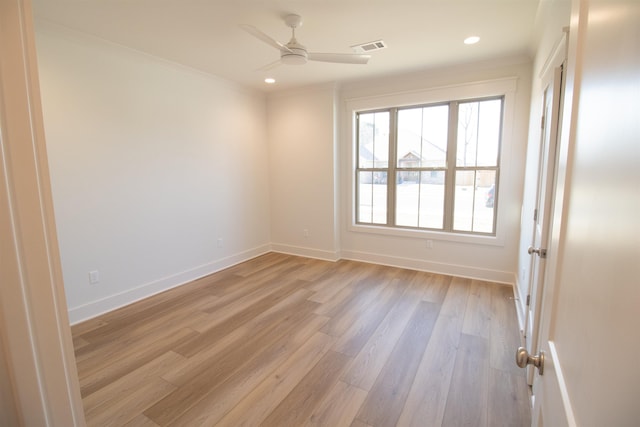 spare room with crown molding, ceiling fan, and light wood-type flooring