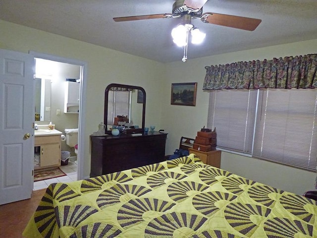 bedroom featuring ensuite bath, ceiling fan, and sink