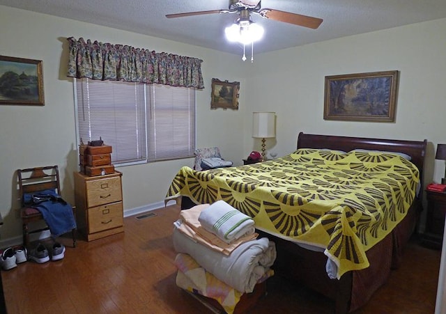 bedroom featuring ceiling fan and dark wood-type flooring