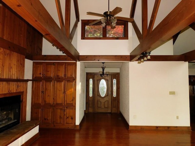 entrance foyer featuring dark hardwood / wood-style flooring, ceiling fan, and high vaulted ceiling