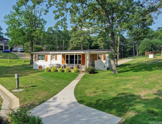 ranch-style home with covered porch and a front yard