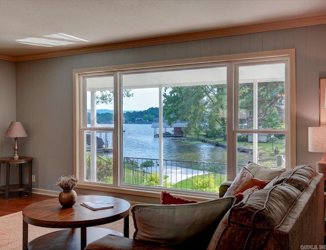 interior space with hardwood / wood-style floors, a water view, and a healthy amount of sunlight