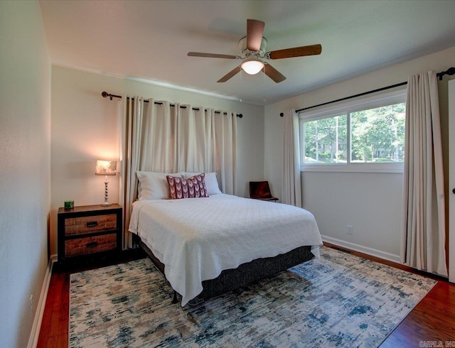 bedroom featuring dark hardwood / wood-style flooring and ceiling fan