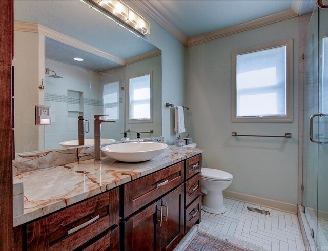 bathroom featuring crown molding, vanity, an enclosed shower, and toilet