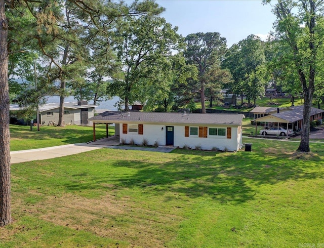 view of front facade with a carport and a front yard