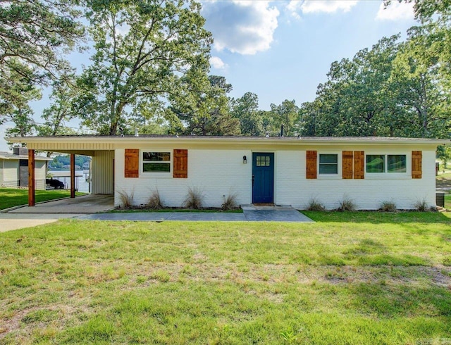 ranch-style home featuring a front yard and a carport