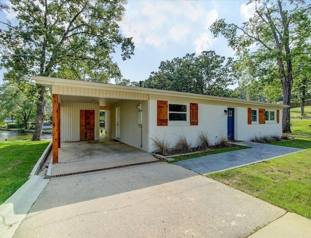 ranch-style home featuring a front yard and a carport