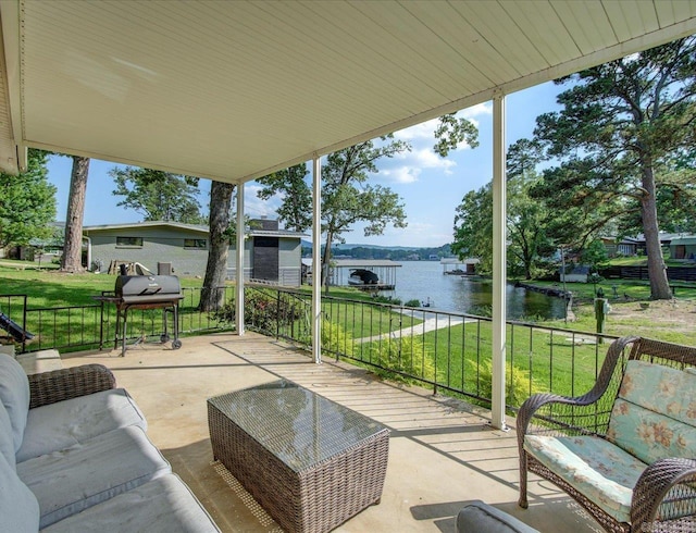 view of patio with a water view and a grill